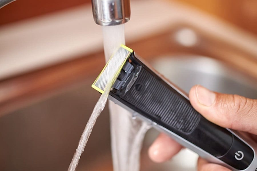 Cleaning beard trimmer with tap water